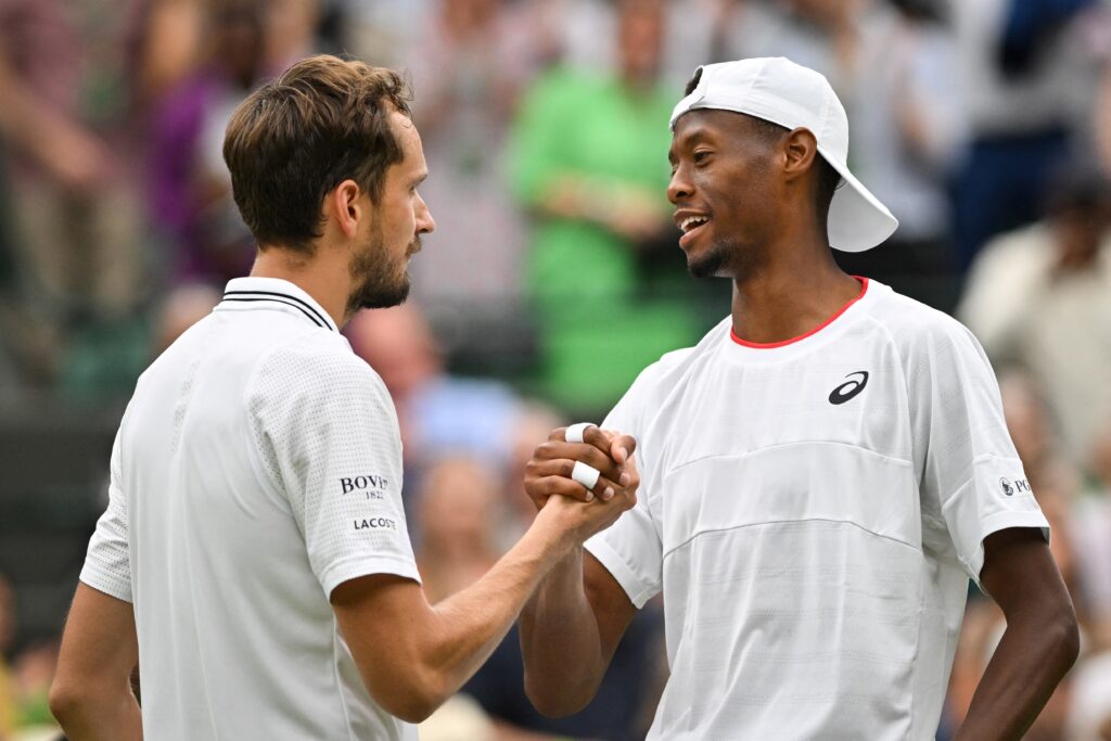Russia's Daniil Medvedev (L) shakes hands after winning against US player Christopher Eubanks during their men's singles quarter-finals tennis match on the tenth day of the 2023 Wimbledon Championships at The All England Lawn Tennis Club in Wimbledon, southwest London, on July 12, 2023.