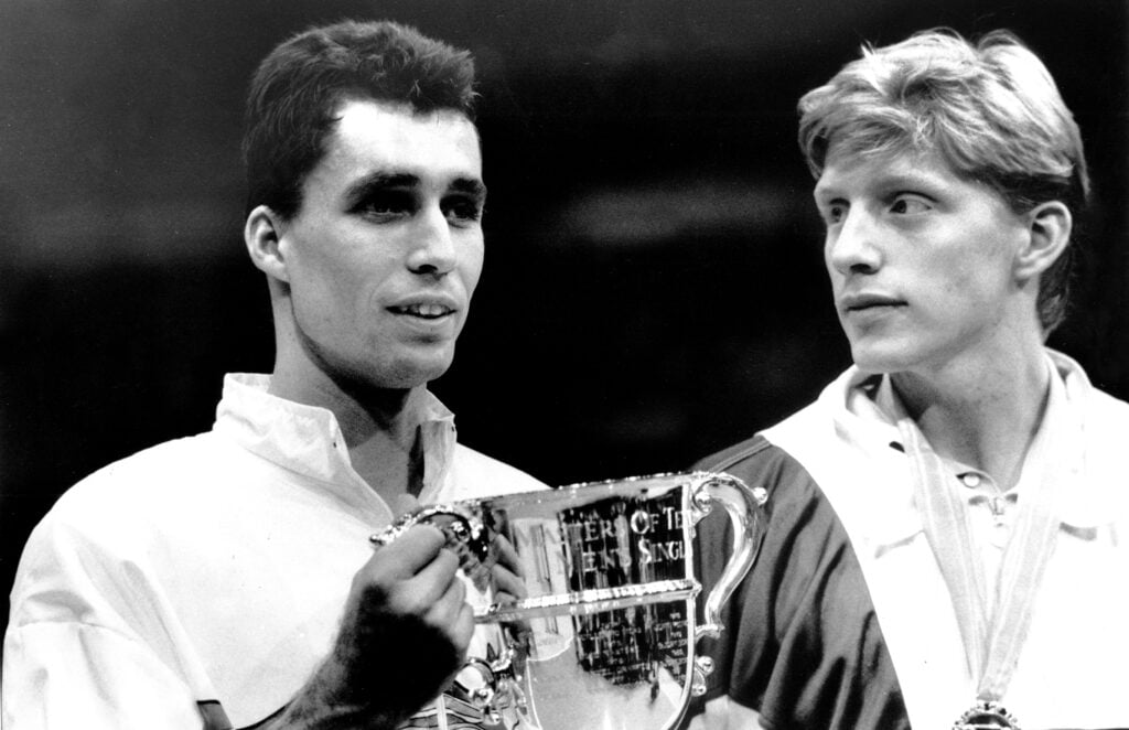 Ivan Lendl holds trophy from the Nabisco Masters after beating Boris Becker (r), as Becker looks on at Madison Square Garden. Lendl won after beating Becker 6-4,6-4,6-4.