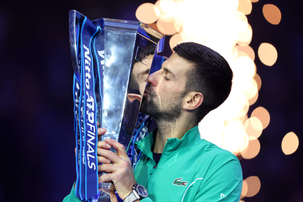 Novak Djokovic of Serbia kisses the Nitto ATP Finals trophy after victory against Jannik Sinner of Italy in the Men's Singles Finals between Jannik Sinner of Italy and Novak Djokovic of Serbia on day eight of the Nitto ATP Final.