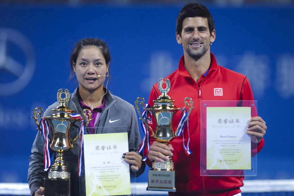 Serbian professional tennis player Novak Djokovic and Chinese professional tennis player Li Na attend a charity event ahead of the 2013 China Open at National Tennis Center on September 27, 2013 in Beijing, China.