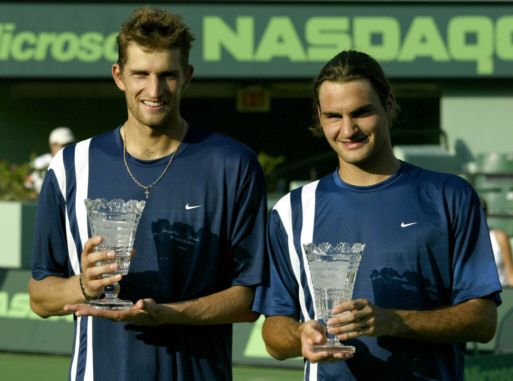 Max Mirnyi and Roger Federer pose for photographers after defeating Leander Paes and David Riki in the men's doubles finals of the Nasdaq-100 Open on March 29, 2003 at the Tennis Center at Crandon Park in Miami, Florida.