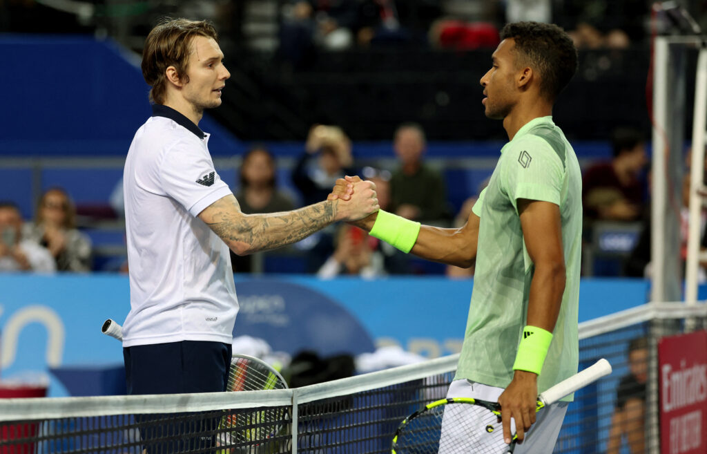 Kazakhstan's Alexander Bublik (L) shakes hand to Canada's Felix Auger Aliassime (R) during their semi-final tennis match at the Open Sud de France ATP World Tour in Montpellier, southern France, on February 3, 2024. Alexander Bublik won three sets 4-6,6-4,6-4.