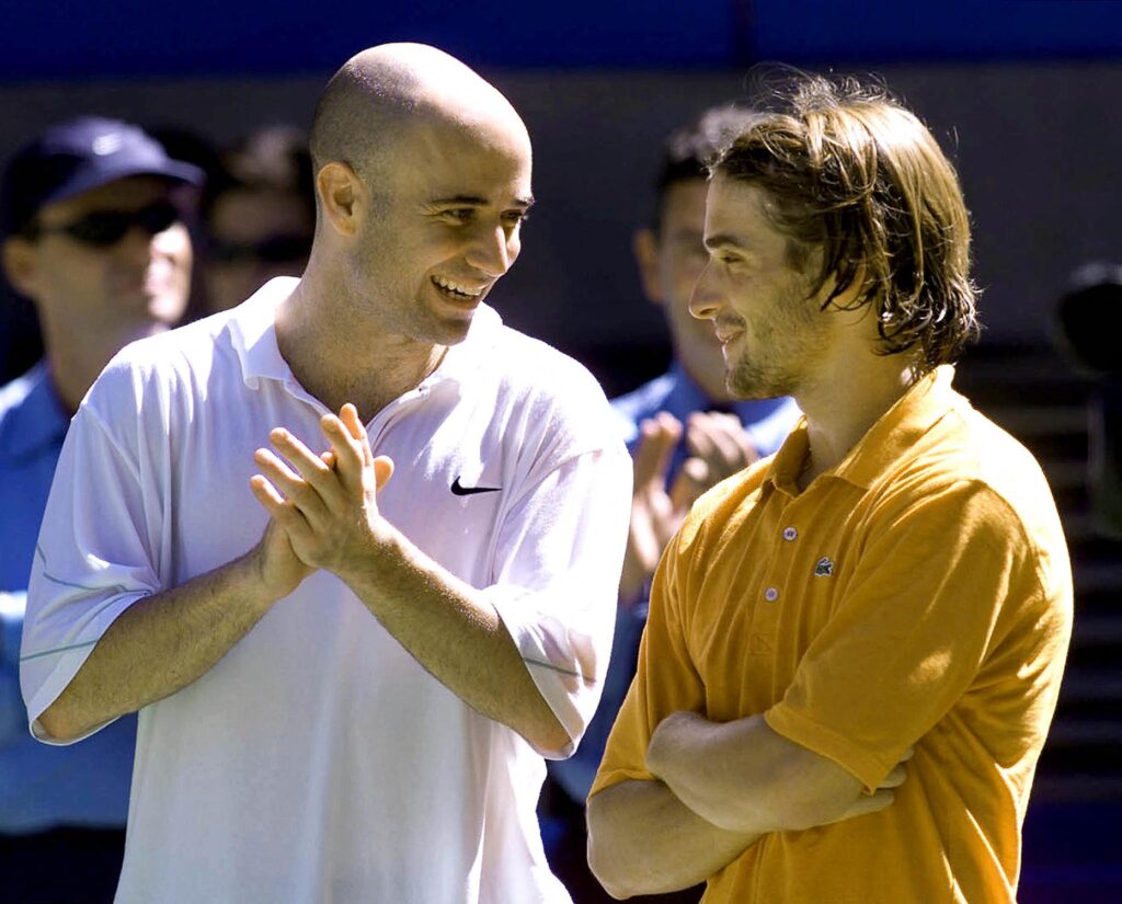 Andre Agassi from the US (L) and Frenchman Arnaud Clement chat before the trophy ceremony which followed their final match at the Australian Open, 28 January 2001 in Melbourne. Agassi won in straight sets: 6-4, 6-2, 6-2.