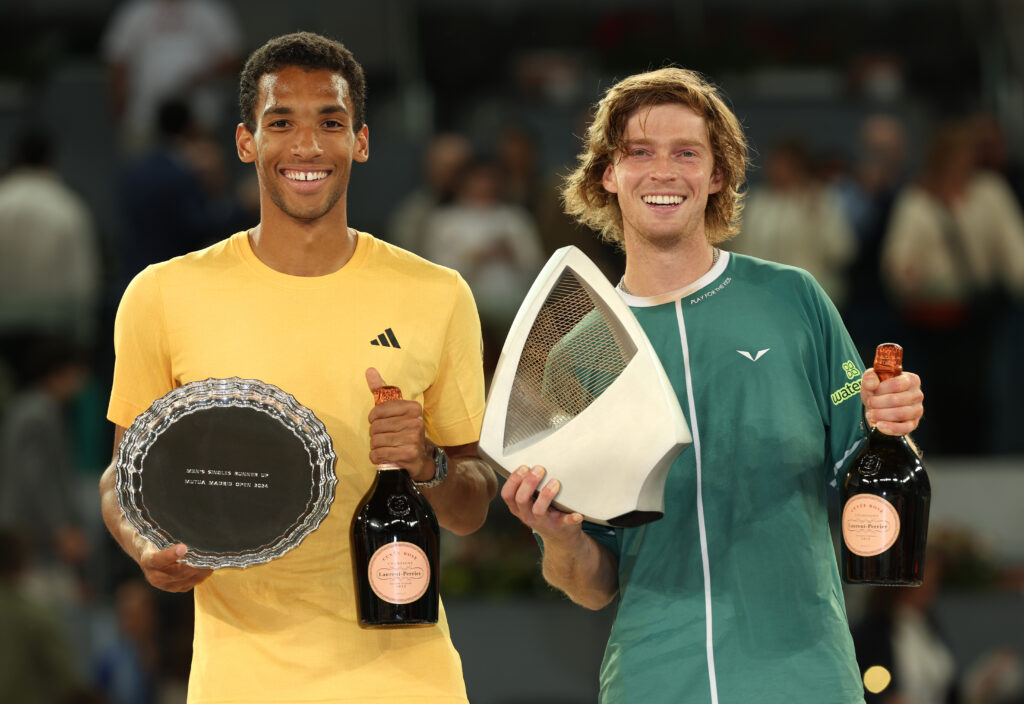 Felix Auger-Aliassime of Canada poses with the Runner Up trophy alongside Andrey Rublev with the Mutua Madrid Open trophy following the Men's Singles Final match on Day Thirteen of Mutua Madrid Open