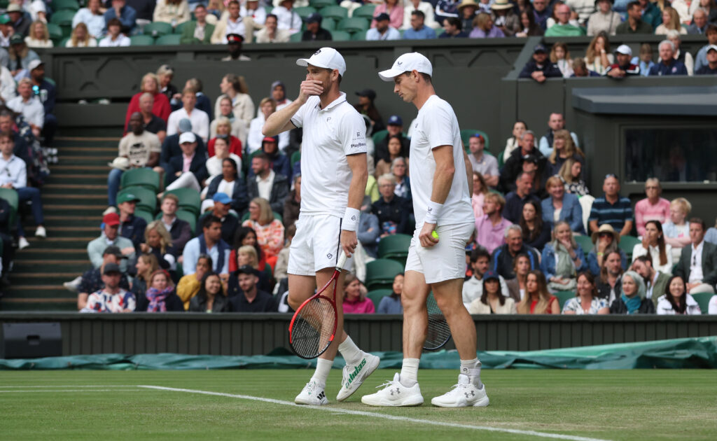 Jamie and Andy Murray chat whilst on court
