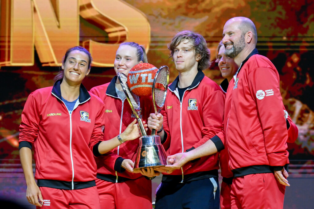 Falcons team members (L-R) Denis Shapovalov, Elena Rybakina, Andrey Rublev, Caroline Garcia and captain John-Laffnie De Jager lift the championship trophy after defeating the Hawks team and becoming the champion of the tournament during the 2024 World Tennis League in Abu Dhabi, United Arab Emirates on December 22, 2024.