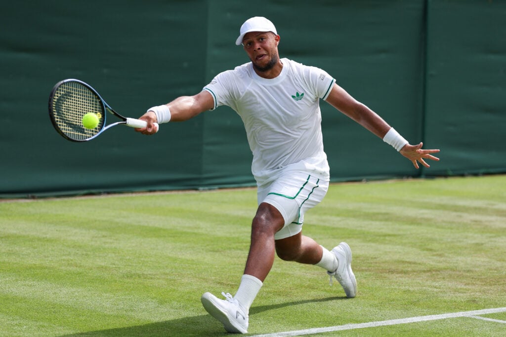 Britain's Jay Clarke plays a forehand return to Britain's Daniel Evans during their men's singles first round tennis match on the second day of the 2025 Wimbledon Championships at The All England Lawn Tennis and Croquet Club in Wimbledon, southwest London, on July 1, 2025.