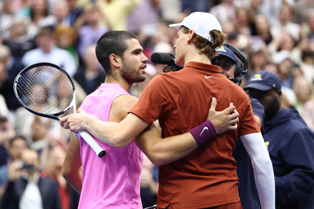 Spain's Carlos Alcaraz (L) greets Italy's Jannik Sinner after Alcaraz won the men's singles final tennis match on day fifteen of the US Open tennis tournament at the USTA Billie Jean King National Tennis Center in New York City on September 7, 2025.