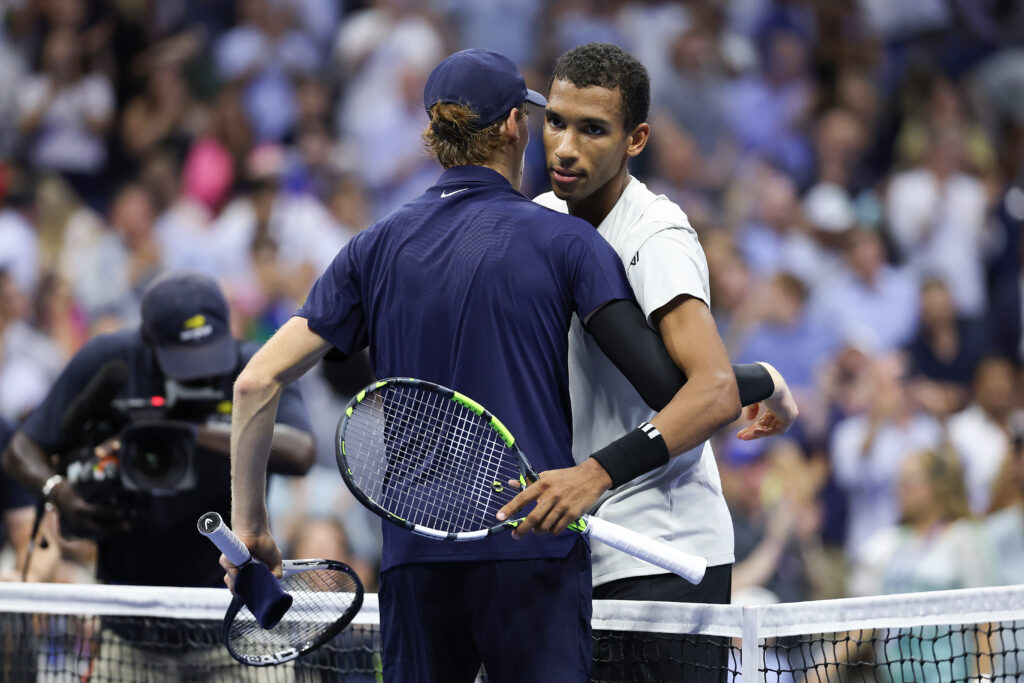 Jannik Sinner of Italy embraces Felix Auger-Aliassime of Canada after defeating him in four sets during their Men's Semifinal match on Day Thirteen of the 2025 US Open at USTA Billie Jean King National Tennis Center on September 5, 2025 in the Flushing neighborhood of the Queens borough of New York City.