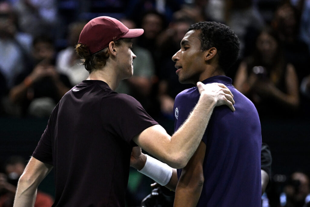 Winner Italy's Jannik Sinner cheers Canada's Felix Auger-Aliassime (R) at the end of their men's singles final match on day seven of the Paris ATP Masters 1000 tennis tournament at the Paris La Défense Arena