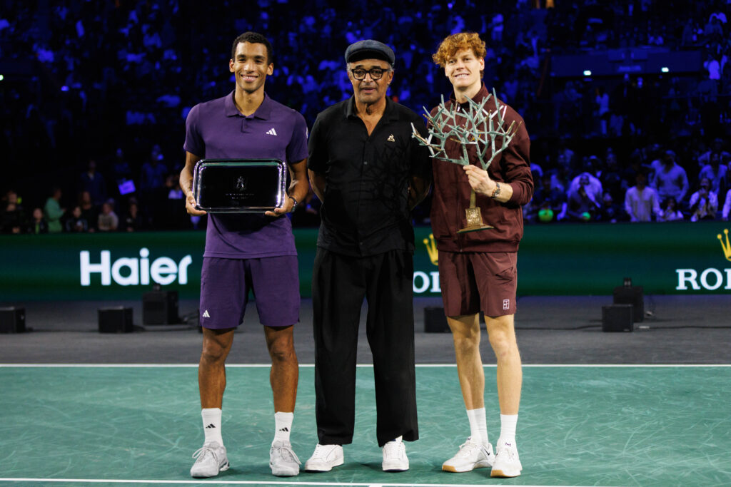 Jannik Sinner of Italy, Felix Auger-Aliassime of Canada and Yannick Noah pose for a photo on the podium after the Men's Singles Final