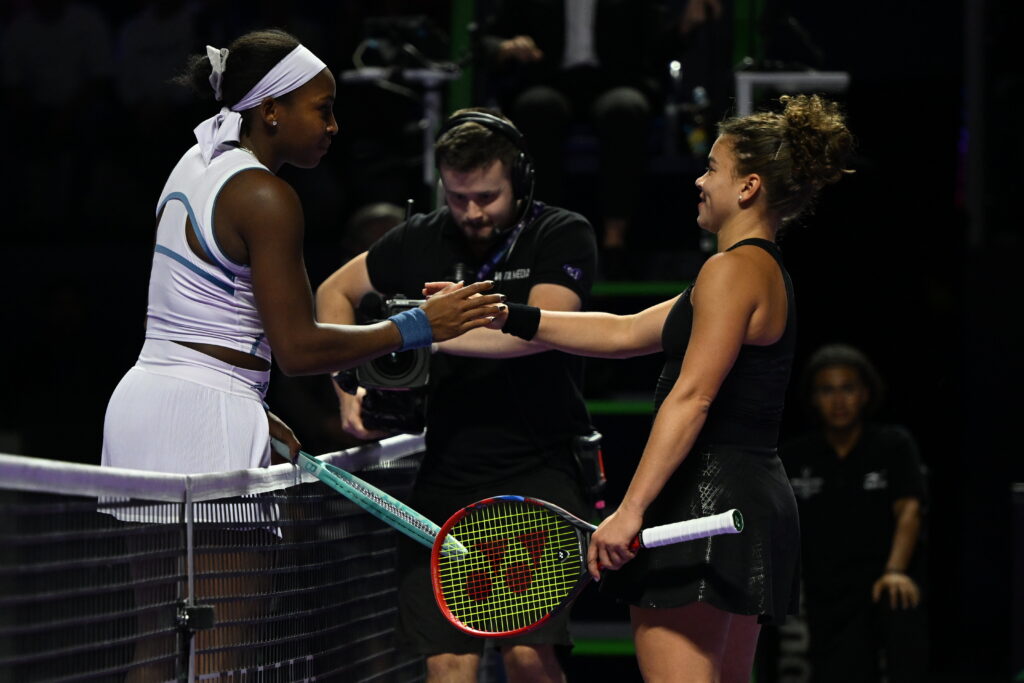 Coco Gauff (L) of the United States and Jasmine Paolini (R) of Italy shake hands during their second group-stage match on Day 4 of the 2025 WTA Finals, part of the Hologic WTA Tour