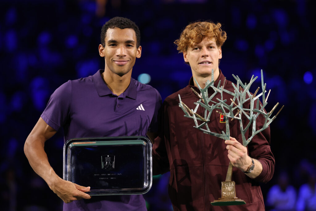 Felix Auger Aliassime of Canada and Jannik Sinner of Italy poses for a photo with their Runners-Up trophy and Rolex Paris Masters trophy after the Final match on day seven of the Rolex Paris Masters 2025 on November 02, 2025 in Nanterre, France.