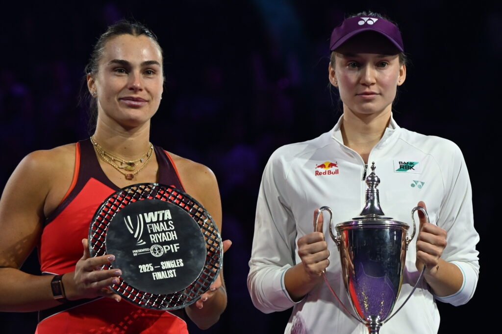 Elena Rybakina (R) of Kazakhstan lifts the Billie Jean King trophy during the award ceremony after defeating Aryna Sabalenka (L) in the Singles Final of the WTA Finals Riyadh, part of the Hologic WTA Tour, at King Saud University Indoor Arena in Riyadh, Saudi Arabia, on November 8, 2025.