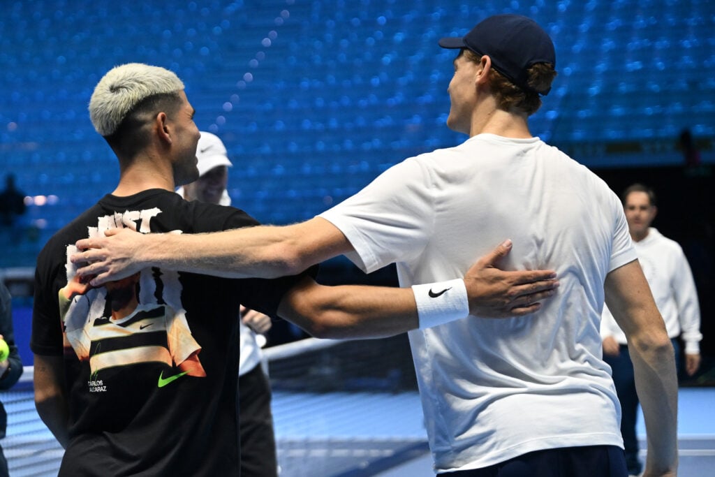 Carlos Alcaraz and Jannik Sinner greet each other after a training session prior to the Nitto ATP Finals 2025 at Inalpi Arena on November 07, 2025 in Turin, Italy.