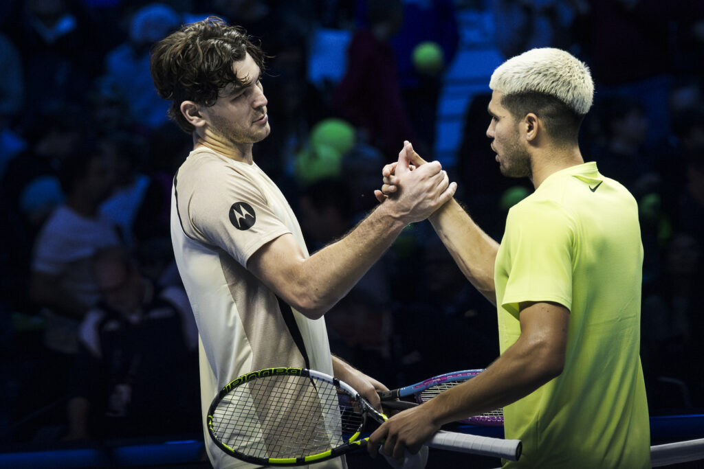 Taylor Fritz (L) of USA shakes hands with Carlos Alcaraz of Spain at the end of their round robin singles match during day three of the Nitto ATP Finals 2025. Carlos Alcaraz won the match 6-7(2), 7-5, 6-3.