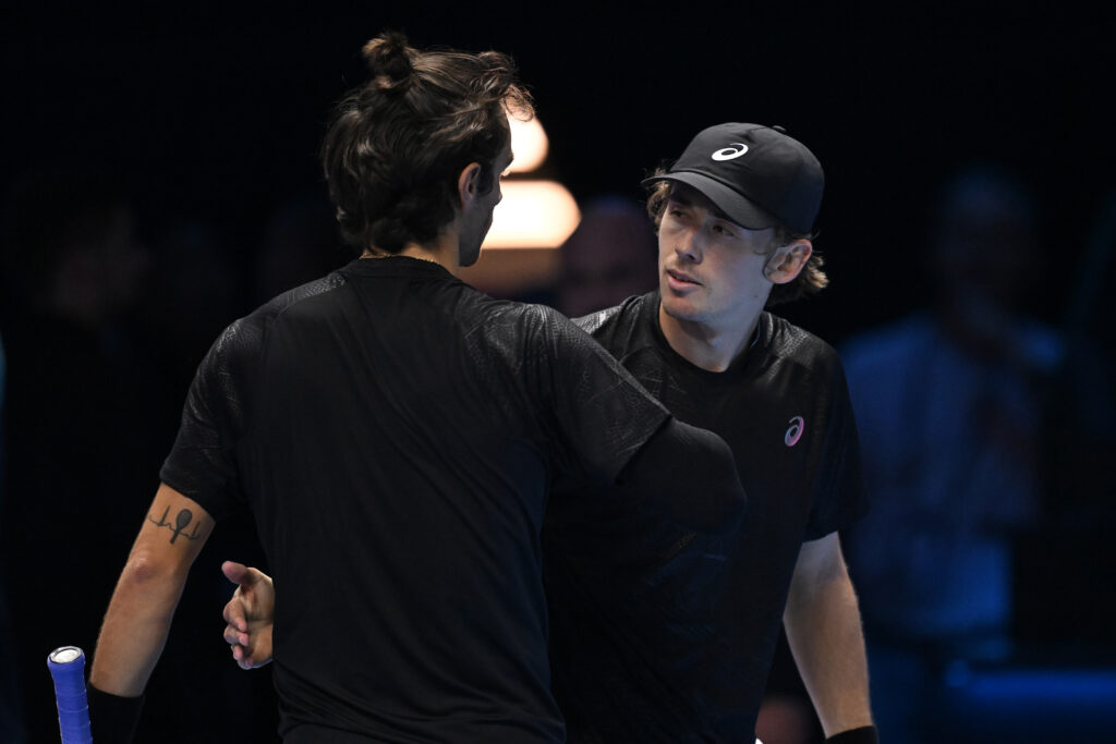 Lorenzo Musetti of Italy shake hands with Alex de Minaur of Australia after the Men's Singles Group Stage match on day three of the Nitto ATP Finals 2025 at Inalpi Arena on November 11, 2025 in Turin, Italy.