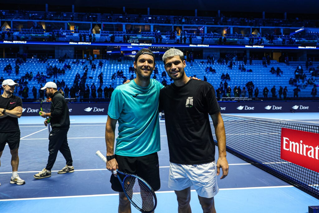 Joao Sousa of Portugal poses with Carlos Alcaraz of Spain before playing in the Men's Singles Round match against Felix Auger-Aliassime of Canada during day seven of the Nitto ATP Finals 2025 at Inalpi Arena in Turin, Italy, on November 15, 2025.