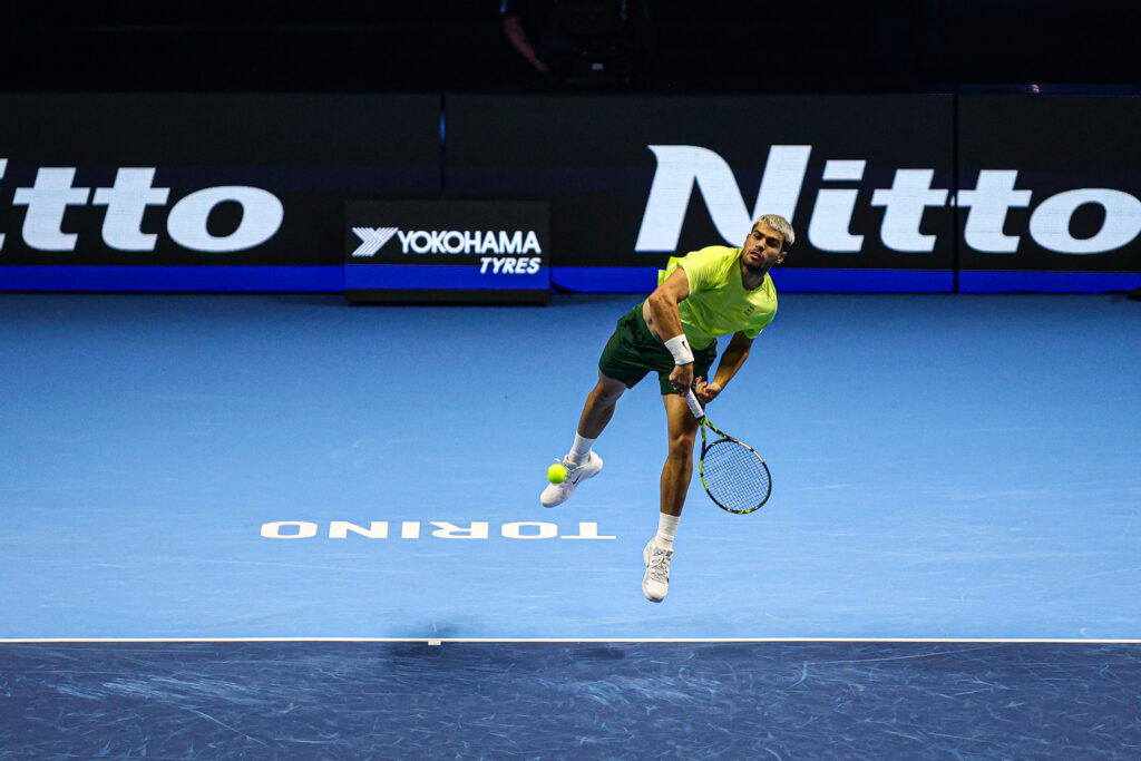 Carlos Alcaraz serves