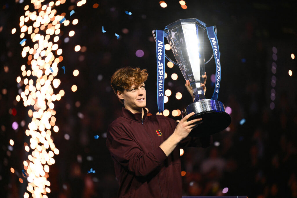 Italy's Jannik Sinner lifts the trophy after winning over Spain's Carlos Alcaraz at the end of the men's single final match at the ATP Finals tennis tournament, in Turin, on November 16, 2025.