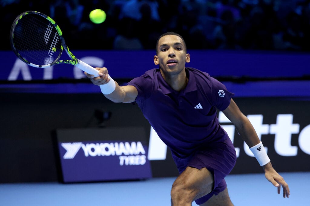Felix Auger-Aliassime of Canada plays a forehand in his Men’s Singles Semi Final match against Carlos Alcaraz of Spain on day seven of the Nitto ATP Finals 2025 at Inalpi Arena on November 15, 2025 in Turin, Italy.