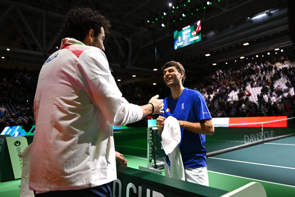 Matteo Berrettini holds out his hand to Flavio Cobolli