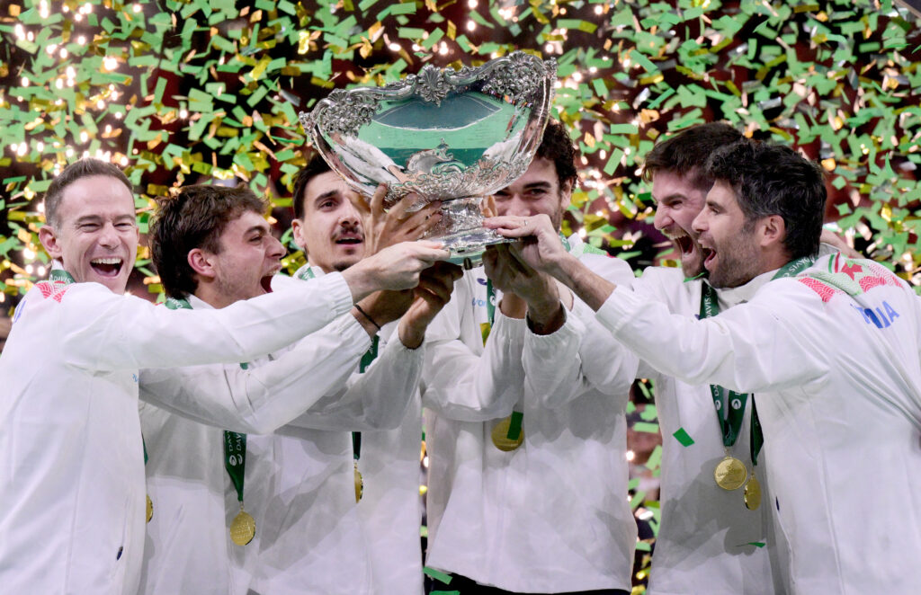 Italy's team captain Filippo Volandri (L) and Italy's team players lift the David Cup trophy after their victory over Spain in their 2025 Davis Cup.