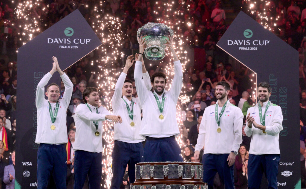 Italy's Matteo Berrettini (C) surrounded by teammates lifts the David Cup trophy after their victory over Spain in their 2025 Davis Cup men's single final tennis match at the Super Tennis Arena in Bologna.