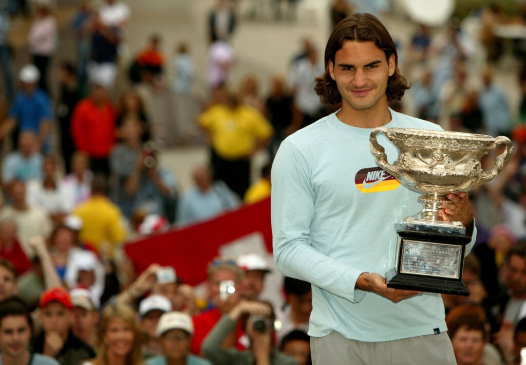 Roger Federer of Switzerland greets fans as he holds the trophy for winning the Australian Open Grand Slam against Marat Safin of Russia during day fourteen of the Australian Open.