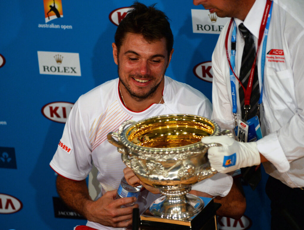 Switzerland's Stanislas Wawrinka reacts as the trophy is placed in front of him during a press conference following his men's singles final victory against Spain's Rafael Nadal