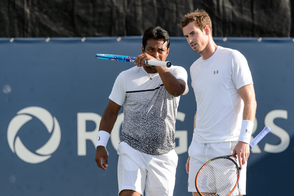 Leander Paes of India speaks with teammate Andy Murray of Great Britain during their doubles match against Jamie Murray of Great Britain and John Peers of Australia on day four of the Rogers Cup