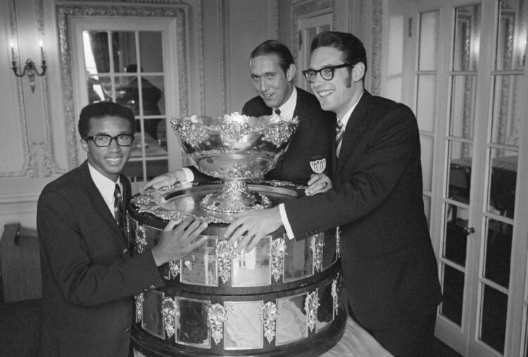 (Original Caption) NEW YORK: Members of the victorious U.S. Davis Cup team proudly display the coveted, honored symbol of the tennis world's highes...