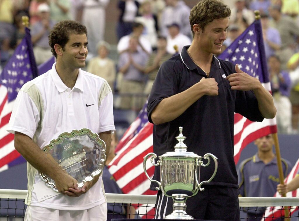 Pete Sampras (L) of the US watches as Marat Safin of Russia celebrate after he beat Sampras of the US in the men's final of the US Open Tennis Tournament 10 September, 2000 in Flushing Meadows, NY. Safin won 6-4, 6-3, 6-3.