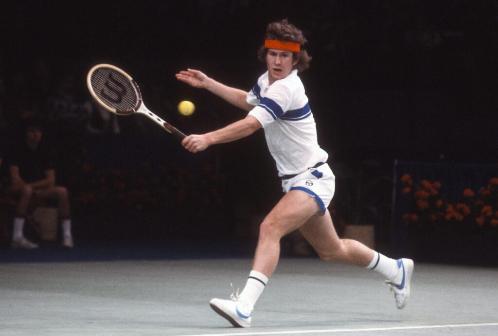 John McEnroe of the United States hits a return during a match in the 1978 Davis Cup finals December 10, 1978 at the Mission Hills Country Club in Rancho Mirage, California.
