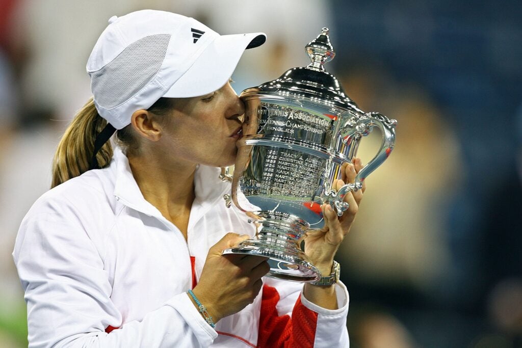 Justine Henin of Belgium celebrates with the trophy after defeating Svetlana Kuznetsova of Russia by a score of 6-1, 6-3 to win the Women's Singles Finals on day thirteen of the 2007 U.S. Open at the Billie Jean King National Tennis Center on September 8, 2007.