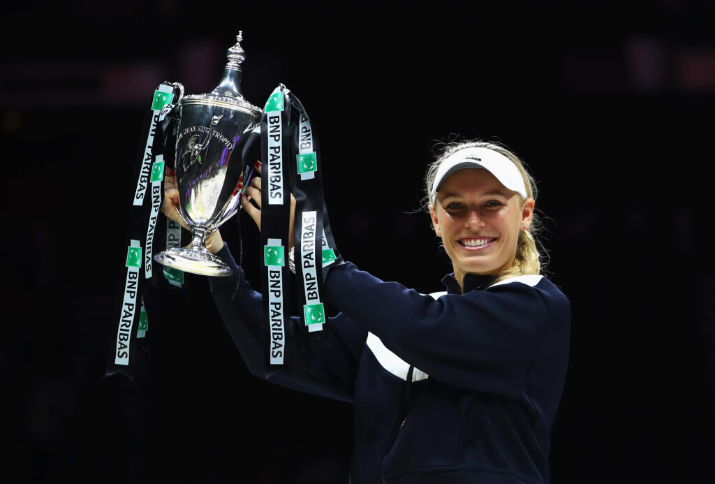 Caroline Wozniacki of Denmark celebrates victory with the Billie Jean King trophy in the Singles Final against Venus Williams of the United States during day 8 of the BNP Paribas WTA Finals.