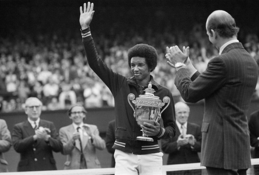 Arthur Ashe with the Wimbledon trophy after he beat the defending champion Jimmy Connors in four sets, 6-1, 6-1, 5-7, 6-4 6th July 1975.