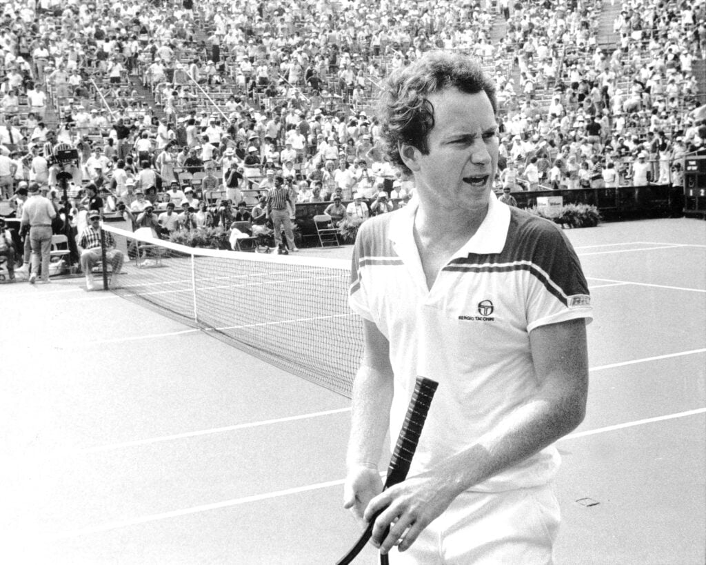 John McEnroe disputes call during loss to Bill Scanlon.