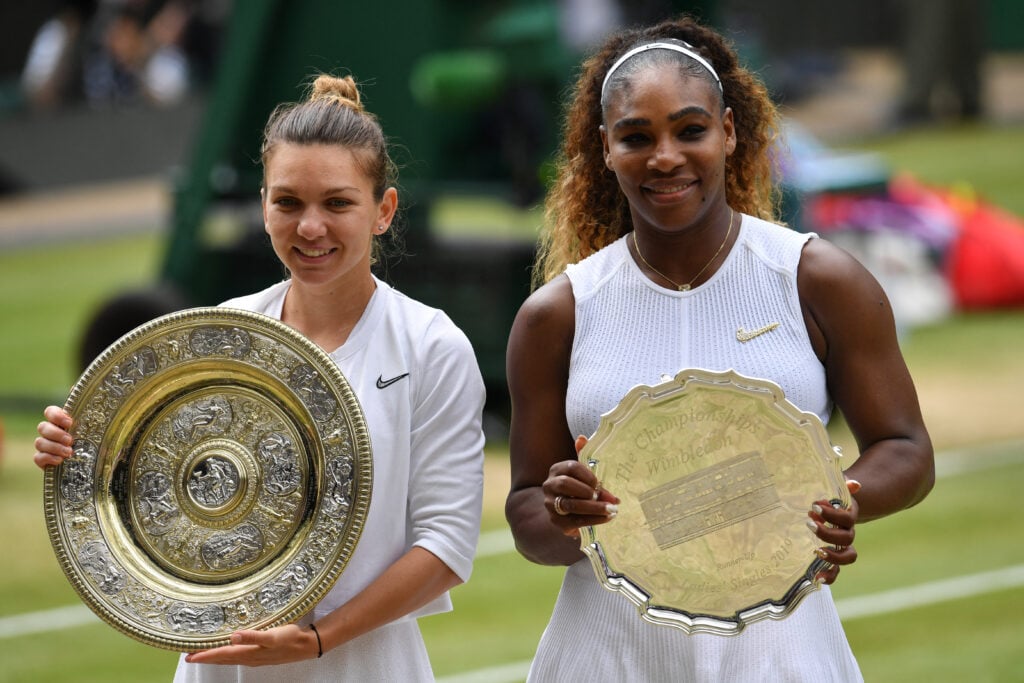 Romania's Simona Halep (L) poses with the Venus Rosewater Dish trophy (L) and US player Serena Williams poses with the runners up trophy after Halep won their women's singles final on day twelve of the 2019 Wimbledon Championships at The All England Lawn Tennis Club in Wimbledon, southwest London, on July 13, 2019.