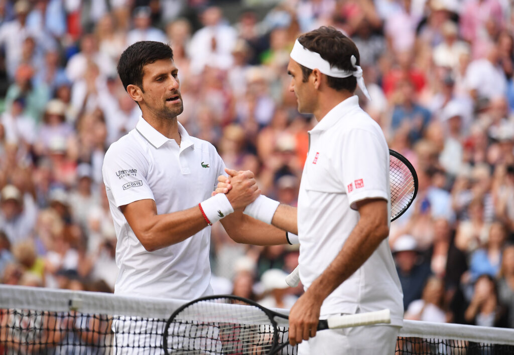 Novak Djokovic of Serbia shakes hands with Roger Federer of Switzerland at the net following victory in his Men's Singles final