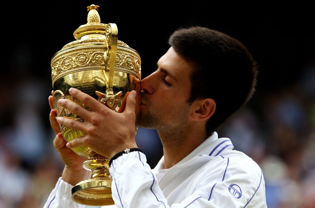 Novak Djokovic of Serbia kisses the championship trophy after winning his final round Gentlemen's match against Rafael Nadal of Spain on Day Thirteen of the Wimbledon Lawn Tennis Championships at the All England Lawn Tennis and Croquet Club on July 3, 2011 in London, England.