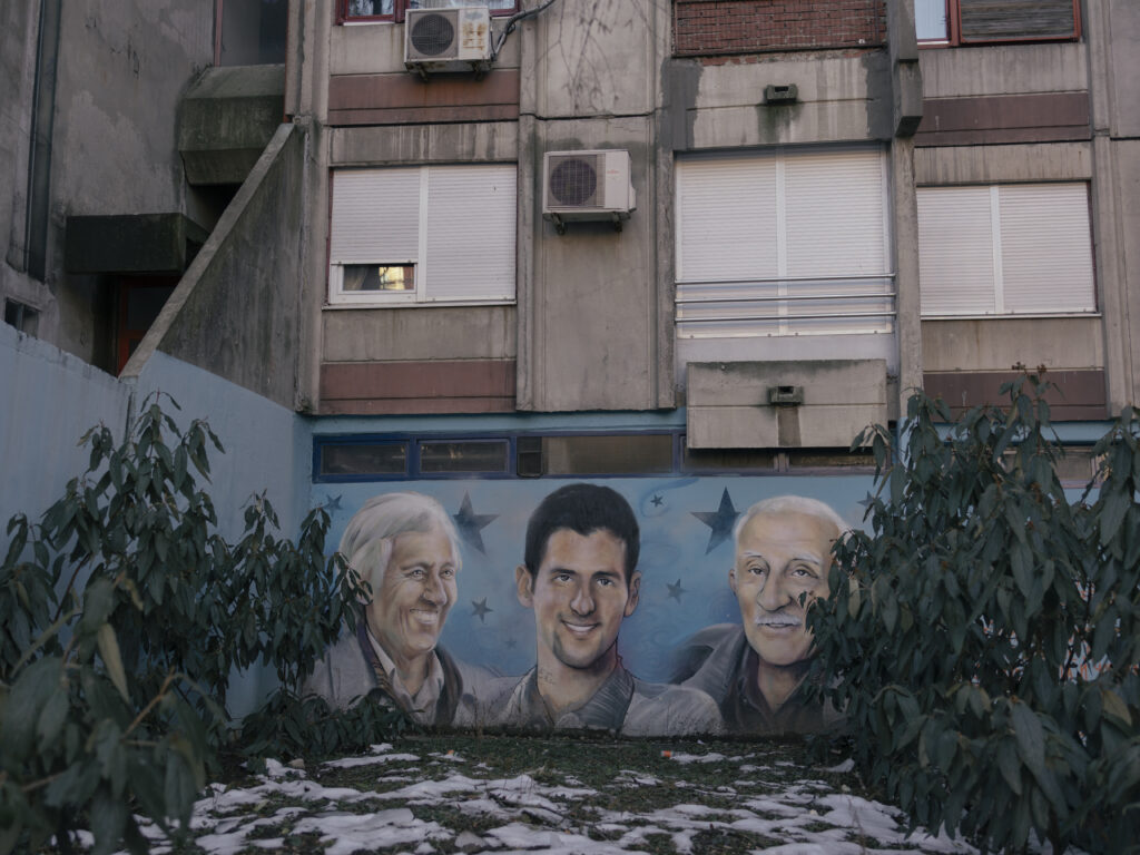 A mural depicting Serbian tennis player Novak Djokovic (centre), his first coach Jelena Gencic (left) and his grandfather Vladimir Djokovic (right).