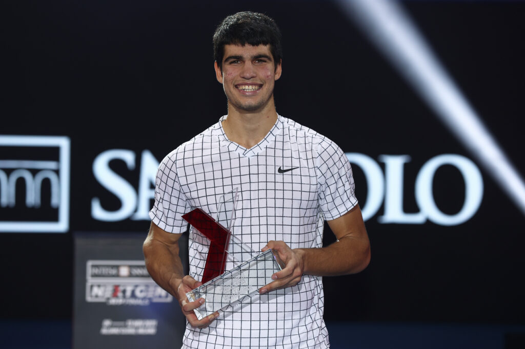 Carlos Alcaraz of Spain celebrates with the trophy after his win over Sebastian Korda of USA in the final match during Day Five of the Next Gen ATP Finals