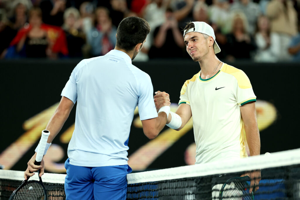 Novak Djokovic of Serbia embraces Dino Prizmic of Croatia after winning his round one singles match during day one of the 2024 Australian Open at Melbourne Park on January 14, 2024 in Melbourne, Australia.