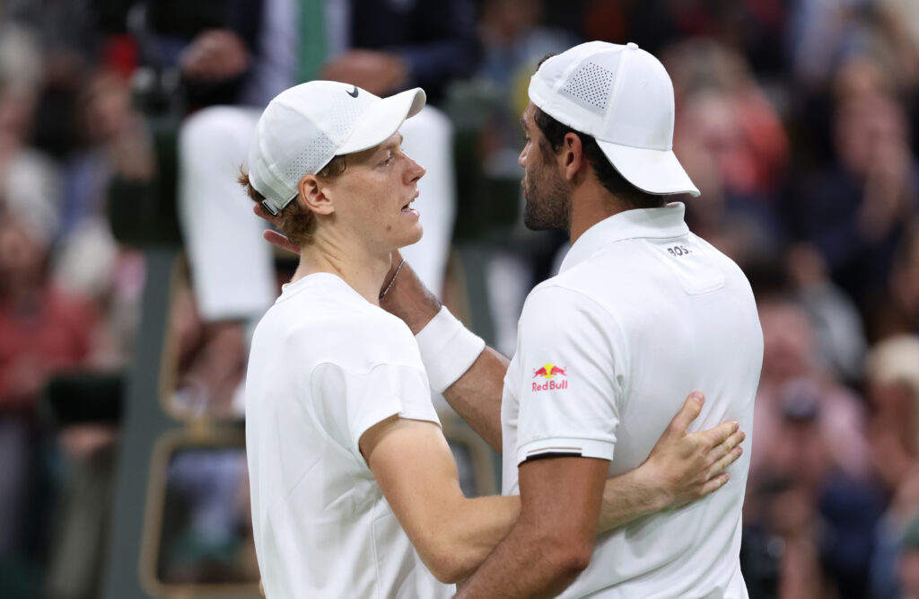 Jannik Sinner of Italy embraces Matteo Berrettini of Italy at the net following victory in his Gentlemen's Singles second round match during day three of The Championships Wimbledon 2024 at All England Lawn Tennis and Croquet Club on July 03, 2024 in London, England.