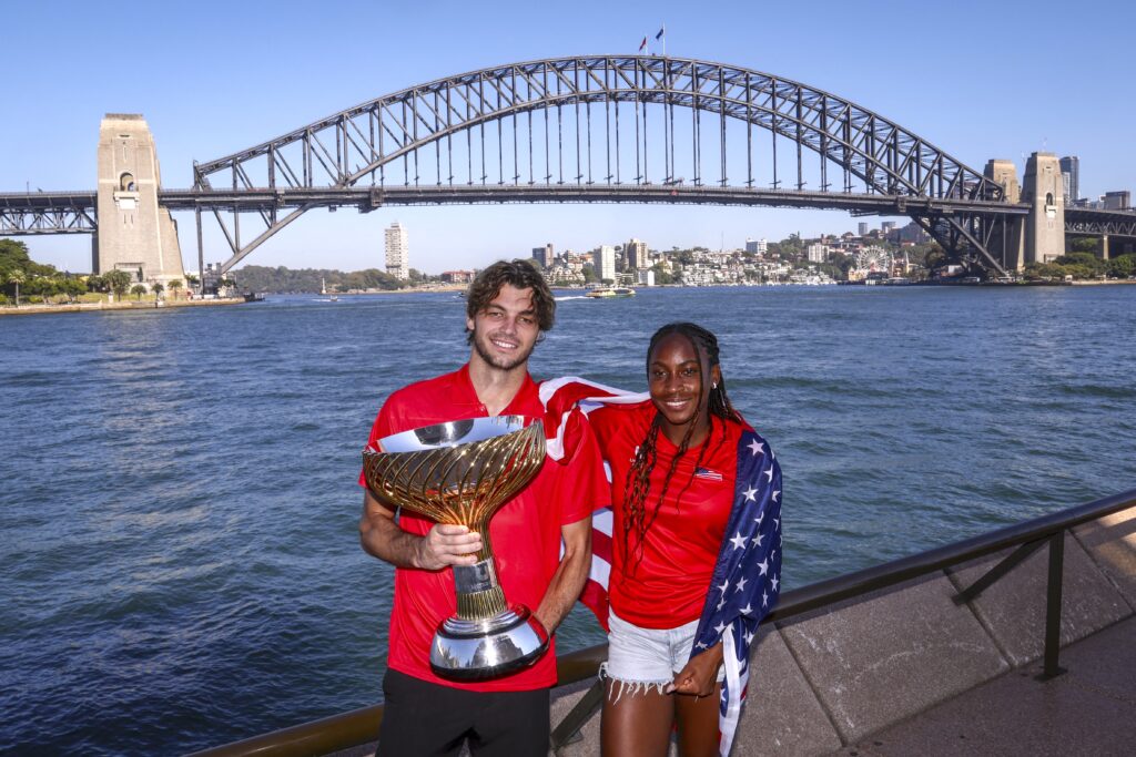 Team USA tennis players Taylor Fritz (L) and Coco Gauff pose with the United Cup Trophy in front of the Sydney Harbour Bridge during a media event in Sydney on January 6, 2025, after defeating Poland in the final of the United Cup tennis tournament on January 5.