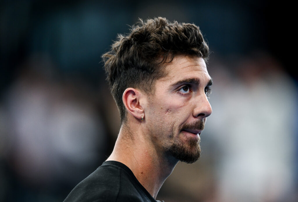 Thanasi Kokkinakis of Australia apologises to the crowd after pulling out of his match with Sebastian Korda of USA with a shoulder injury during day four of the 2025 Adelaide International at Memorial Drive on January 09, 2025 in Adelaide, Australia.