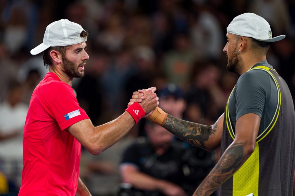 Jacob Fearnley (L) of Great Britain shakes hands with Nick Kyrgios of Australia after victory in the Men's Singles First Round match during day two of the 2025 Australian Open at Melbourne Park on January 13, 2025