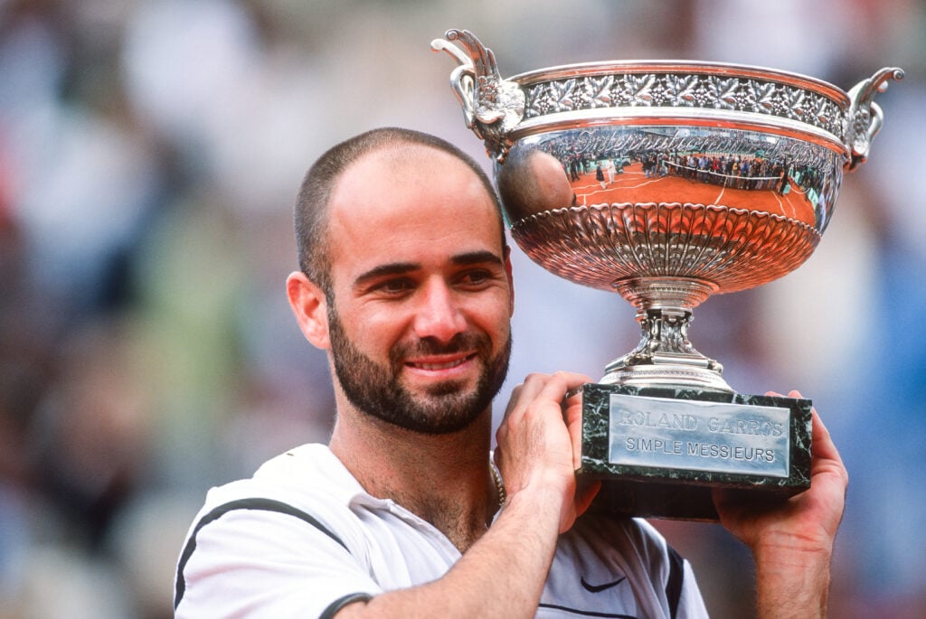 Andre Agassi of the USA lifts the trophy after defeating Andrei Medvedev of the Ukraine during the Men's Singles Final, during the French Open at Roland Garros on June 6th, 1999 in Paris, France.