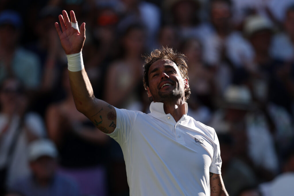 Fabio Fognini of Italy acknowledges the crowd following defeat against Carlos Alcaraz of Spain in the Gentlemen's Singles first round match on day one of The Championships Wimbledon 2025